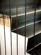 Staircase, Metal Railing, and Metal Tread When the family moved in, Cara warned the children not to touch the staircase’s steel rods or “the house would fall down,” but William seems unconcerned.  Photos from A Darkened Cedar Dwelling in Portland Embodies “Less But Better” Design