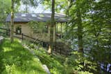 Exterior, House Building Type, Gable RoofLine, Shingles Roof Material, and Wood Siding Material The 1,000-square-foot house, surrounded by lake and greenery, has multiple skylights to let in the sun.  Photos from This Lakeside Cabin in New York Is Offbeat in the Best Way
