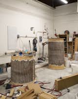 Wood cylinders are wrapped in rubber bark to create molds for the installation's trees.  Photo 7 of 16 in Watch: Inside the Studio of Designer and Materials Master Fernando Mastrangelo