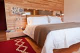 Bedroom, Bed, Medium Hardwood Floor, Table Lighting, Night Stands, and Rug Floor  Photo 4 of 13 in Tierra Patagonia Hotel & Spa by Dwell