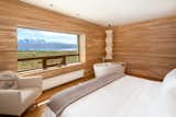 Bedroom, Medium Hardwood Floor, Recessed Lighting, Bed, Chair, and Ceiling Lighting  Photo 9 of 13 in Tierra Patagonia Hotel & Spa by Dwell