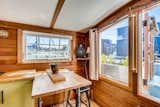 Dining Room, Lamps, Wall Lighting, Medium Hardwood Floor, Table Lighting, Stools, and Bar A lovely breakfast nook has been cleverly built into the corner of the kitchen.  Photos from Snatch Up This Darling Seattle Houseboat For $275K