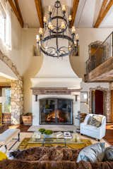 Living Room, Dark Hardwood Floor, Sofa, Pendant Lighting, Chair, Coffee Tables, Rug Floor, Standard Layout Fireplace, and Bench The two-story great room is crowned by a striking chandelier.  Photos from Mel Gibson Lists His Extravagant Malibu Mansion For $14.5M
