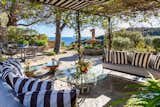 Outdoor, Side Yard, Shrubs, Large Patio, Porch, Deck, and Trees Another angle of the outdoor entertaining space, featuring captivating panoramic views.  Photo 13 of 17 in Mel Gibson Lists His Extravagant Malibu Mansion For $14.5M