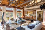 Living, Medium Hardwood, Pendant, Chair, Ceiling, Sofa, Rug, Coffee Tables, and Bench A warm, voluminous family room is located off the kitchen, overlooking beautiful ocean views.  Living Medium Hardwood Pendant Bench Photos from Mel Gibson Lists His Extravagant Malibu Mansion For $14.5M