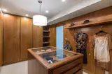 The master suite also includes a spacious walk-in closet with walnut cabinetry.