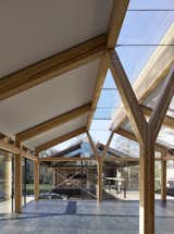 A central "Y" post forms a focal point in each space and supports central roof skylights that extend the entire length of each building.