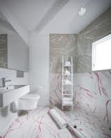 In the bathroom, the ceramic tiles sport a marble faux finish, while other rooms have vinyl or engineered composite tiles with faux terrazzo, wood, or "drawing" finishes.