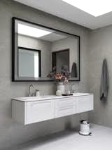 In the master bath, the floating vanity and pedal bin are from Vipp; the mirror was designed by André.