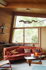 Living Room, Sofa, Rug Floor, Coffee Tables, Chair, Shelves, Medium Hardwood Floor, and Pendant Lighting  Photo 3 of 4 in My House: Writer Susan Orlean’s Modernist Masterpiece in L.A.