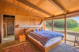 Bedroom, Bed, Chair, Accent Lighting, and Rug Floor Like other areas of the home, nature provides the theme for the light-filled master suite.  Photo 9 of 15 in A Sea Ranch Stunner With a Green Roof Asks $1.3M