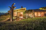 Exterior, Wood Siding Material, Shingles Roof Material, and House Building Type The Kirkwood House gorgeously lit up at night. The architecture is accentuated by the sculptures by local artist Bruce Johnson of Cazadero.  Photo 15 of 15 in A Sea Ranch Stunner With a Green Roof Asks $1.3M