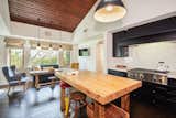 The kitchen features a large, butcher-block island, as well as vaulted, wood-paneled ceiling.  Photo 4 of 9 in John Stamos of “Full House” Lists His Bachelor Pad of 14 Years For $6.75M
