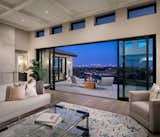 Fotsch reframed the great room, adding 14" to the overall height of the space in order to accommodate eight-foot-tall Kolbe multi-slide doors with transom windows above—dramatically highlighting the home’s most spectacular view.