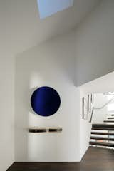 An Anish Kapoor sculpture hangs in the entryway.