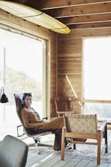 Kate sits in the living room, which is outfitted with vintage Eames and Jens Risom chairs.
