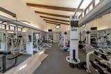Exposed wooden beams continue into the estate's well-equipped gym.