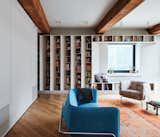 To elegantly showcase the couple's extensive book collection without cluttering the 1,100-square-foot home, the New York–based firm has created a custom library via angled shelving.