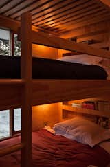 Within the hut, the architects have utilized every inch of available space, including incorporating secret cubby holes into the children's bunkbeds. 