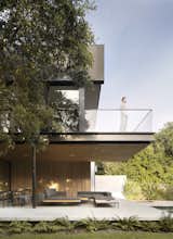 &nbsp;A glass-walled balcony sits directly above the concrete terrace.
