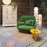 Living Room, Concrete Floor, Chair, Floor Lighting, End Tables, and Wall Lighting Eclectic colors and patterns pop in Moooi's designs.  Photos from 7 Top Rug Makers Whose Designs We’re Dying to Bring Home
