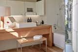 Bath Room, Vessel Sink, Table Lighting, Enclosed Shower, Alcove Tub, and Wood Counter White finishes meet light wood in the stylish bathrooms.  Photo 20 of 24 in Barcelona’s Hottest New Hotel Draws Inspiration From a Rebellious Female Author