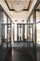 A black-trimmed entrance hall lined with mirrored closets sets an elegant tone.