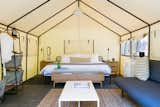 Tent suites are similar in tone to the Airstreams, but offer a more outdoorsy glamping experience. The central pendant light is by In Common With.