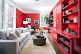 Eye-catching Chinese red lacquered bookshelves line the wall in the home's corner library.