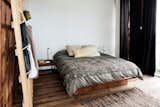 The bedroom features the studio’s coat racks.
