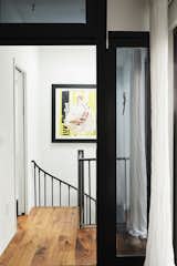 OSSO Architecture renovated Brooklyn loft apartment hallway and spiral staircase