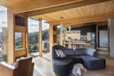 The majority of the structure, including the floor and ceiling, is made of locally grown eucalyptus timber, with some external cedar cladding and steel roofing. In the living area, an Ottawa modular sofa from BoConcept provides a cozy nook for Koa, one of the couple’s two dogs.