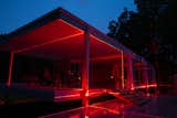 The red laser beams light the home at night, giving it a new, unique aesthetic. 