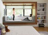 The Patels’ daughters, Maya and Ayla, play in Ayla’s bedroom, which features a corner window seat framed in walnut. The roller shades are from The Shade Store.
