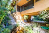 A previous homeowner recreated the open patio and breezeway according to Schindler's original plans. A koi pond with waterfall create an atmosphere of Zen.