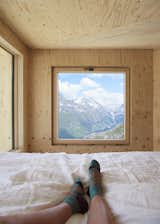 Guests enjoy an unobstructed view of the Engadin Valley from the lofted sleeping area.