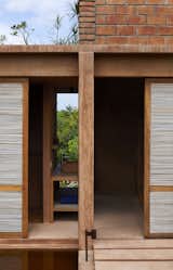 Small walkways cross over the reflecting pool to reach two bedrooms and two bathrooms housed on the opposite side. Sliding doors made of wood and reed divide each area.