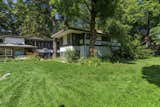 The large backyard offers a grassy area and plenty of mature trees. According to conservation reports, the home was affectionately referred to as the 'Baker Bungalow' by local residents.