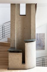 Beech wood floors continue up the spiral staircase. A hollowed-out concrete column rises through the home's three levels, adding a sculptural point of interest to each story.