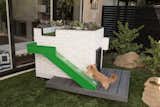 A pup uses the turf ramp to access the "woof deck" for outdoor lounging with a view.