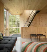 The Saloma Daybed from Westminster Teak, '60s-era Danish stools, and a colorful rug by Angela Adams round out the office. The steel ladder, created by blacksmith Tim Greene at Standfast Works Forge, leads to the rooftop deck.