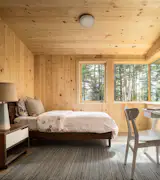 The child’s bedroom features a Chilton bedframe, Schoolhouse Electric bed linens, and an Angela Adams rug. The table and chair are from Blu Dot.