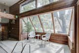 A former patio surrounding the pool is the heart of the new sunroom, with clerestory windows and sloping panes of glass to bring in tons of natural light.  Photo 8 of 14 in This Quirky Abode Built By a Frank Lloyd Wright Apprentice Wants $575K