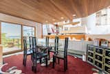 Steps away from the kitchen lies the formal dining area, which offers direct access to the outdoors. The main living area is visible due to the split-level floor plan.