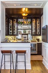 A wet bar appears to be well-stocked and ready for entertaining.