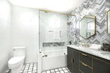 An up-close look at one of the bathrooms. This one was recently remodeled with geometric tile work and a chic gold-trimmed detailing.