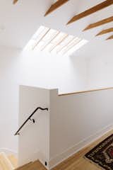The stairs and landing are warmed by a skylight, which directs light throughout different levels of the home.&nbsp;