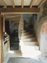 A spiral staircase connects the bedroom and the work space.