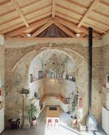 Architect Carlos Garmendia and homeowner Tas Careaga spent three years reviving this 16th-century Basque church near Bilbao, Spain, that had been abandoned since the late 1970s. The architect’s mission was to preserve the original building without hiding the effects of time, while Tas wanted a functional space for living, working, and entertaining. The two friends landed on a design that maintained as much of the ancient stone structure as possible.