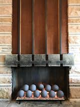 The fireplace holds a modern gas insert. Hall originally built the five-foot-wide fireplace to recirculate heat using inset iron pipes and convection to project warm air throughout the room.